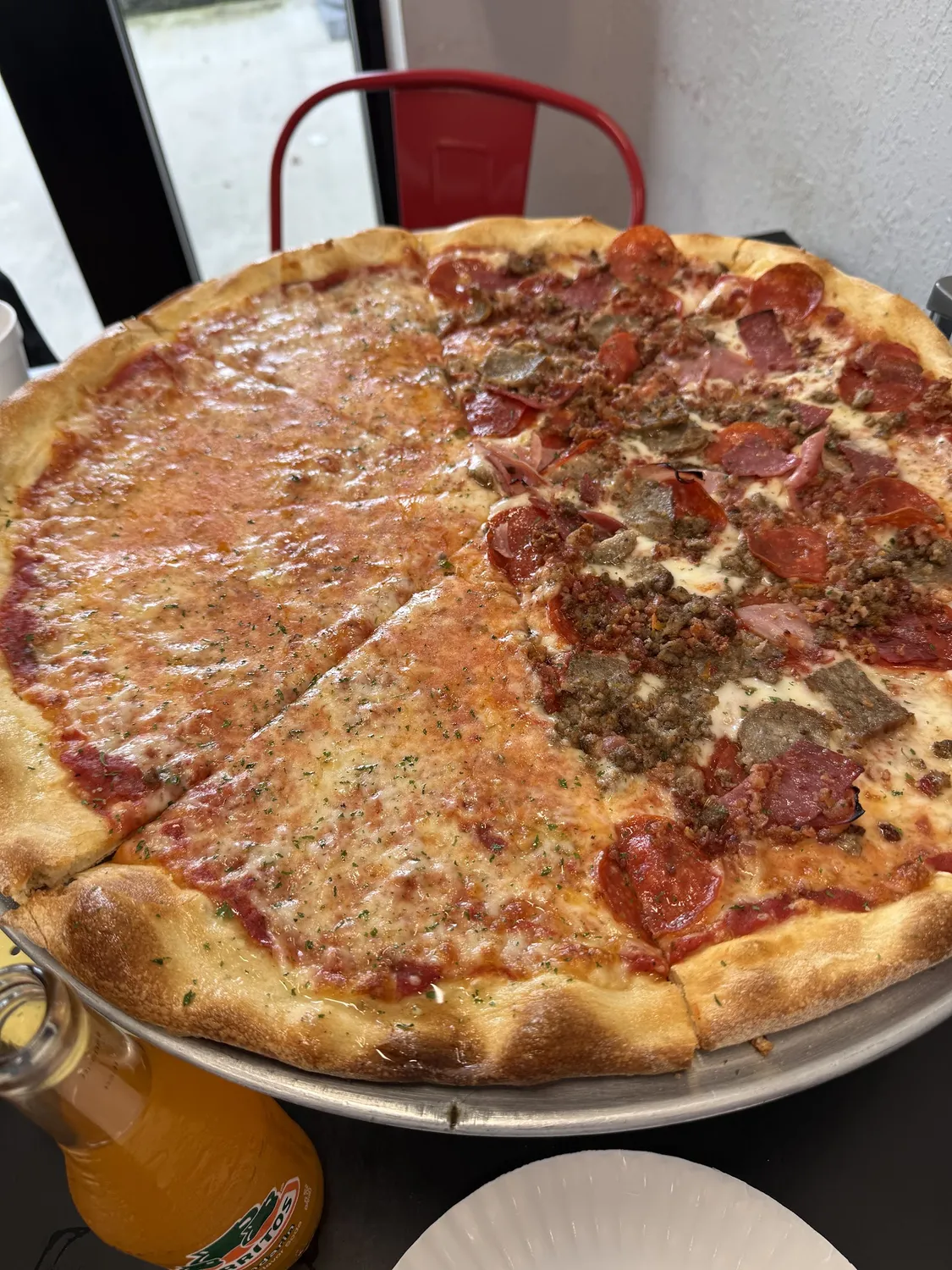 A large New York style pie, half cheese and half pepperoni